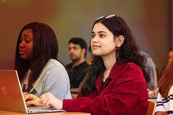 Female student on laptop in classroom