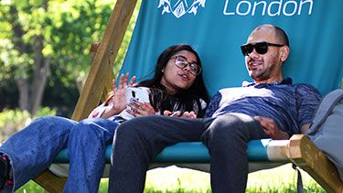 Students chatting while sitting in a giant deckchair