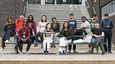 Group of students looking at camera on campus