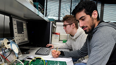 Male student working in electronics lab