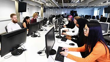 Students working on computers in a PC lab