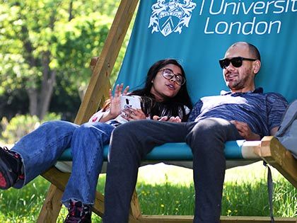 Students chatting while sitting in a giant deckchair